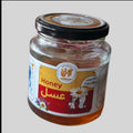 Jar of honey with a label on a light gray background